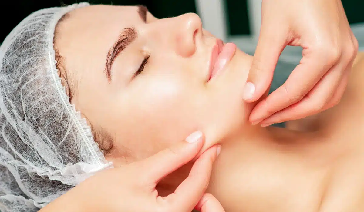 Chin and Neck Liposuction Woman undergoing chin and neck liposuction treatment to contour jawline and enhance facial definition at a cosmetic clinic